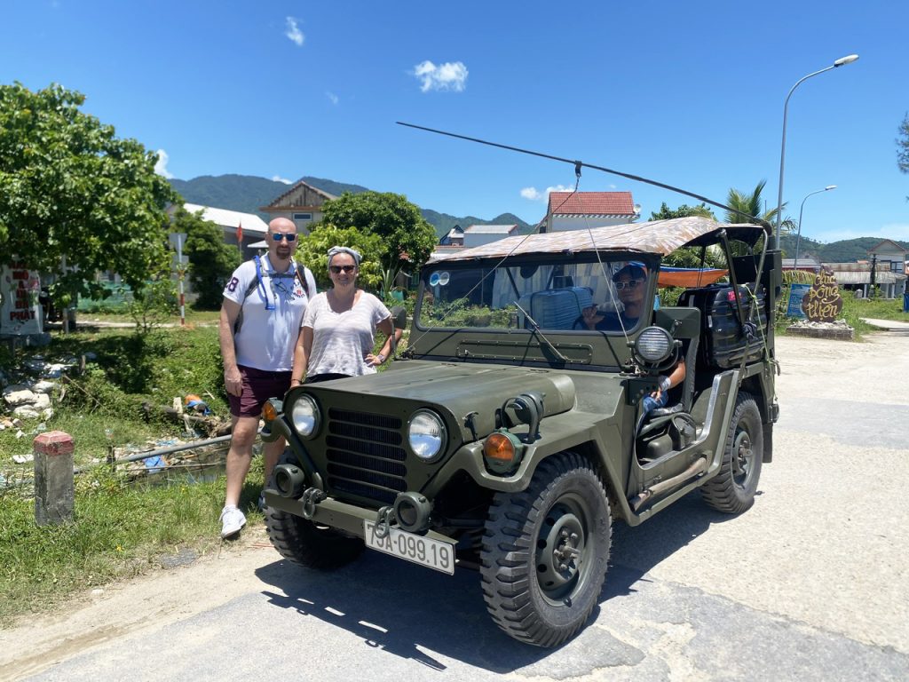 A US Army Jeep driving on a Hai Van Pass tour, offering scenic views.