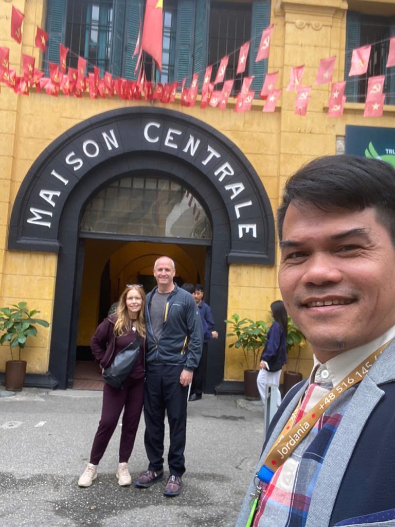 Our guide and US guests reflecting at Hoa Lo Prison – a powerful Hanoi history moment. Guide and US tourists reflecting at the poignant Hoa Lo Prison, Hanoi.