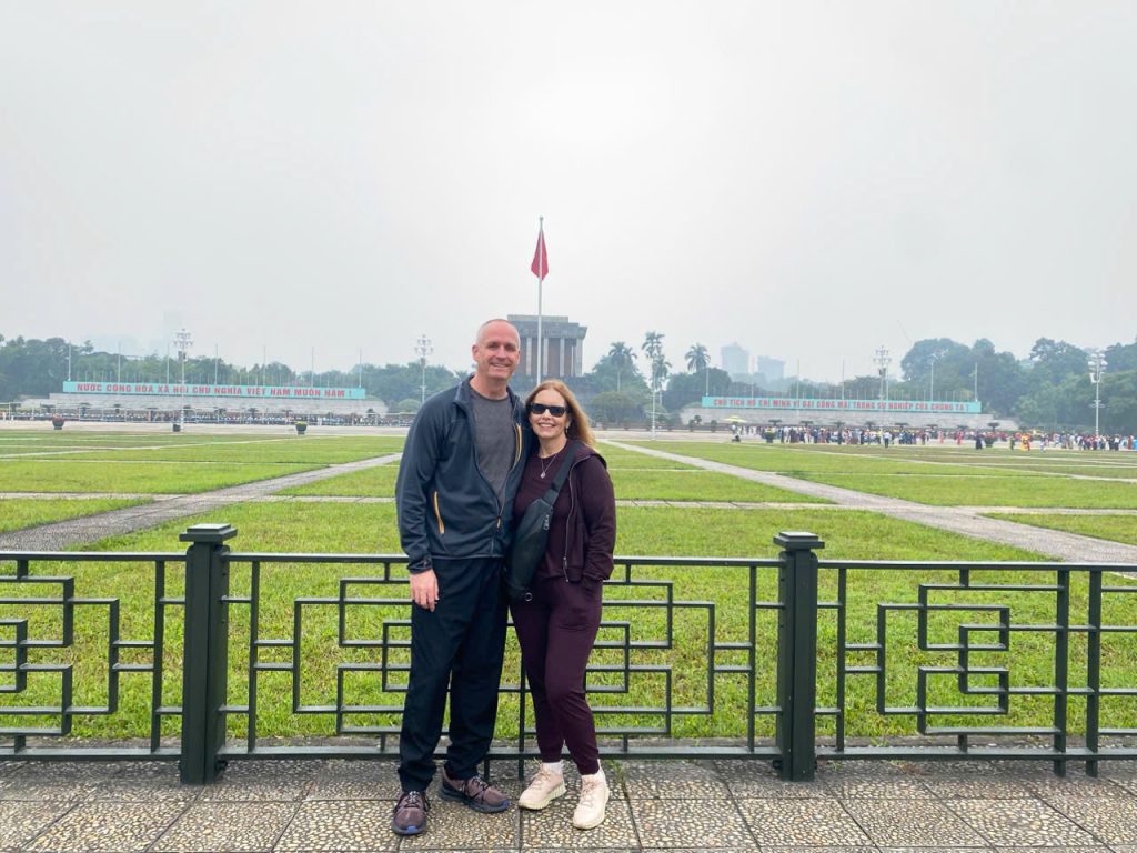 Respectfully observing the majestic Ho Chi Minh Mausoleum, the heart of Hanoi. ourists observing the Ho Chi Minh Mausoleum, Hanoi's historic landmark.