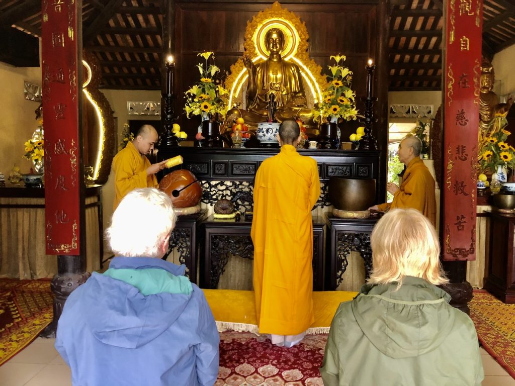 A moment of profound peace listening to the monks’ chanting inside a pagoda. Monks chanting during a ceremony inside a dimly lit pagoda.