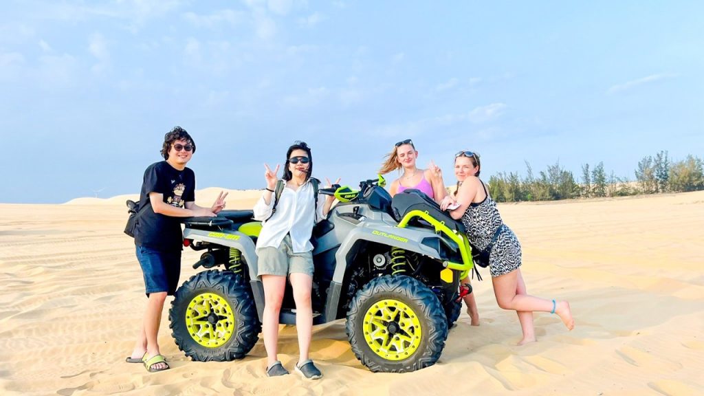 A group rides an ATV on the white sand dunes during a two-day trip to Mui Ne.
