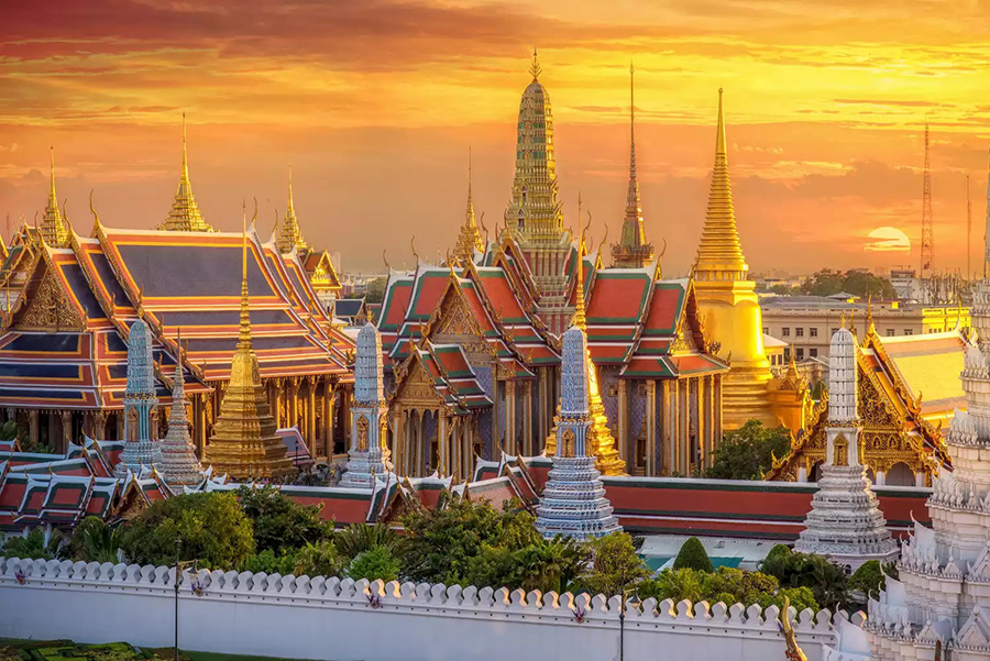 Explore the golden spires and royal architecture of the Grand Palace and Wat Phra Kaew on our private Bangkok Essential Highlights Tour. Grand Palace and Wat Phra Kaew complex at sunset during Bangkok Essential Highlights Tour