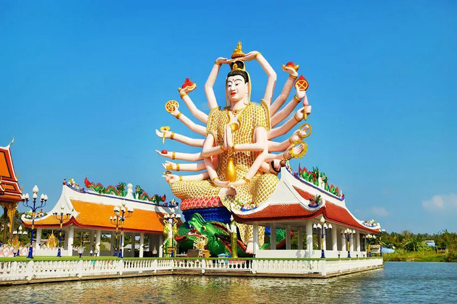 Discover the intricate architecture of Wat Plai Laem before taking in breathtaking ocean views from Lad Koh Viewpoint. Multi armed statue of Guanyin surrounded by a tranquil lake at Wat Plai Laem in Koh Samui