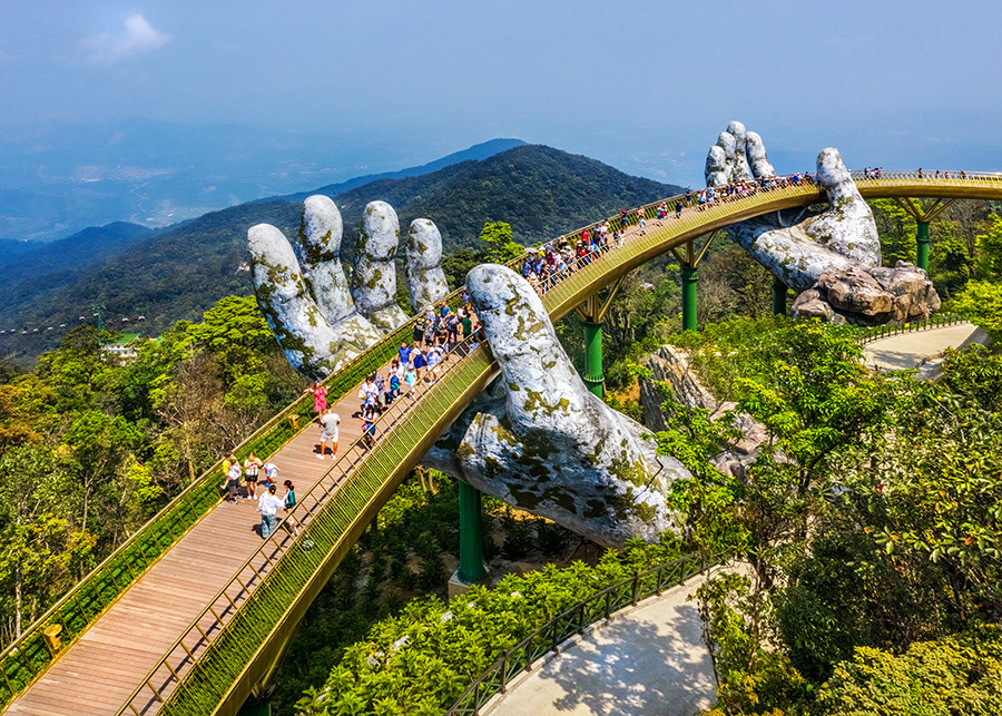 Golden Bridge, Ba Na Hills: Held by giant hands, a spectacular walk. Golden Bridge, Da Nang: Iconic 'hand-held' bridge, stunning mountain views. Luxury Vietnam tour highlight.