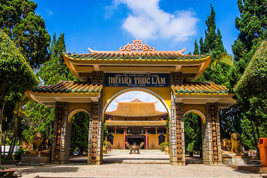 The traditional architecture and peaceful gardens of Truc Lam Zen Monastery overlooking Tuyen Lam Lake.