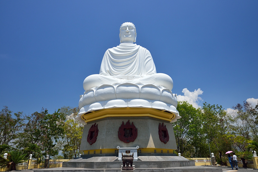 Giant white Gautama Buddha statue seated on a lotus throne at Long Son Pagoda Nha Trang on Nha Trang City Tour.