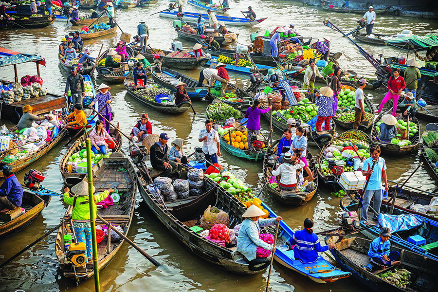 Cai Rang Floating Market: Witness vibrant Mekong Delta life on bustling boats. Cai Rang Floating Market, Vietnam, a key stop on your Vietnam and Cambodia tour.