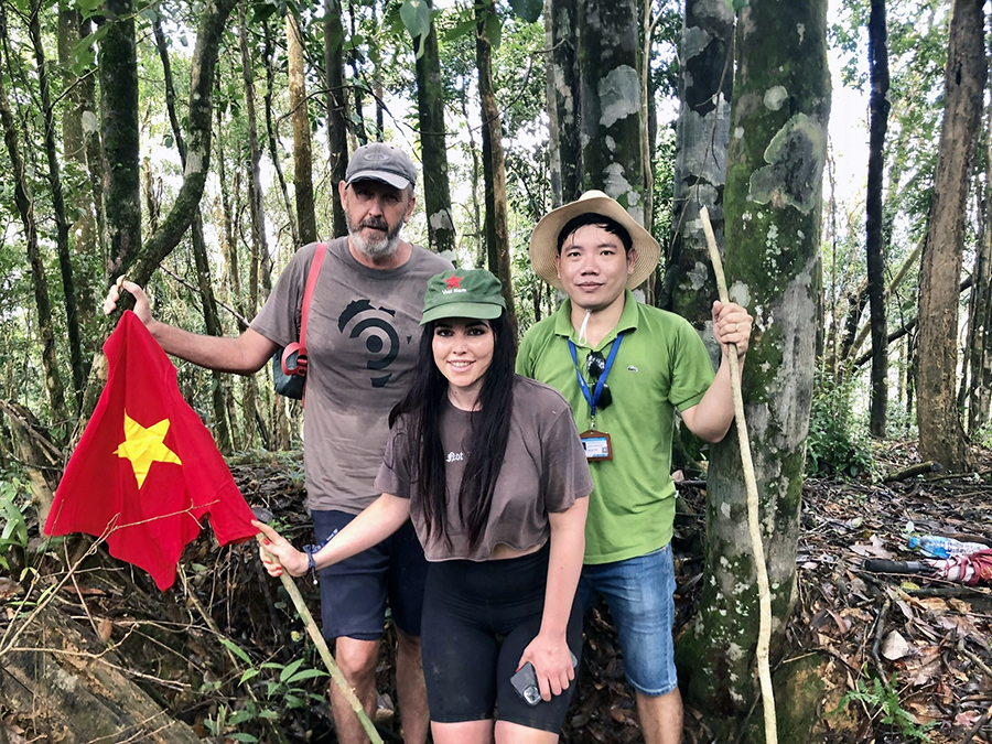 Exploring the historic site of Hamburger Hill, a deep dive into Vietnam War history. A person exploring the foxholes and jungle terrain on the historic battle site of Hamburger Hill.