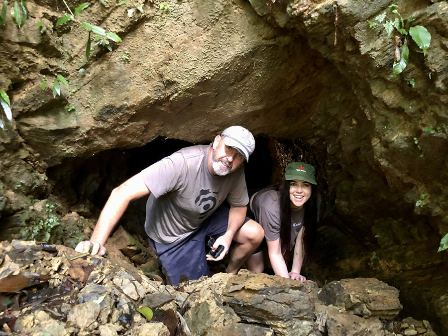 Exploring Hamburger Hill, an immersive journey into a pivotal Vietnam War battle site. A person exploring the historic foxholes and jungle of Hamburger Hill, a Vietnam War battlefield.