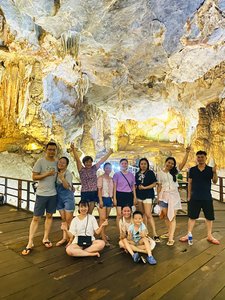 An unforgettable Paradise Cave tour into Vietnam’s longest dry cave and underground palace. A group of customers walks along the wooden boardwalk inside Paradise Cave, a key feature of the tour.