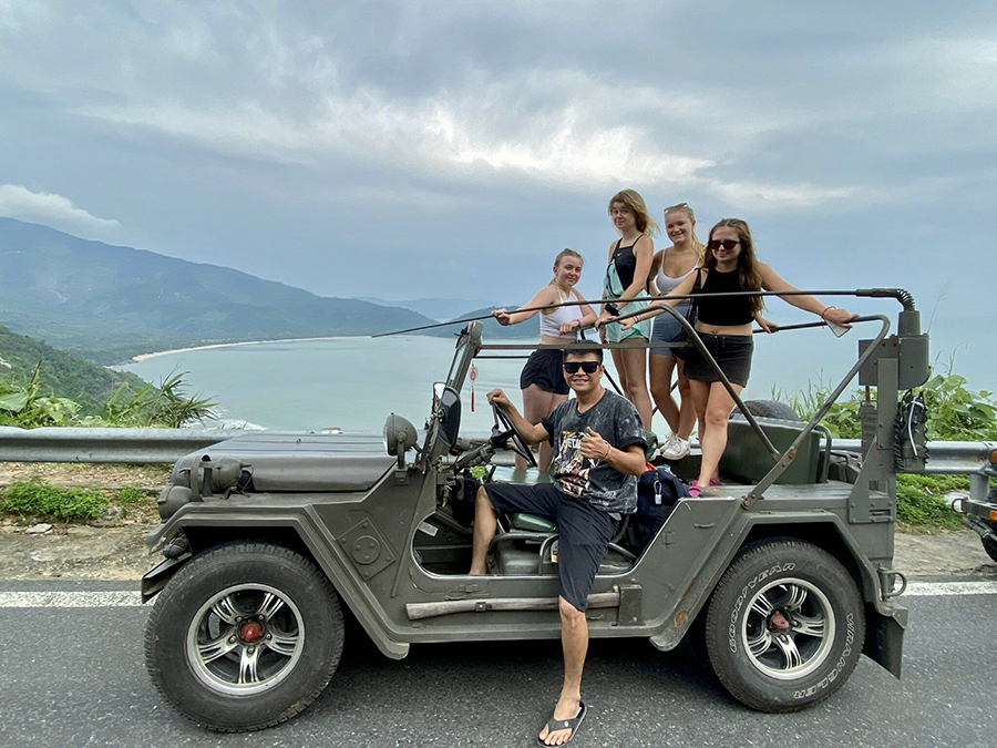 Feel the adventure! Exploring the stunning Hai Van Pass on our Hue to Hoi An Jeep tour. A U.S. Army Jeep driving along the Hai Van Pass on the Hue to Hoi An tour.