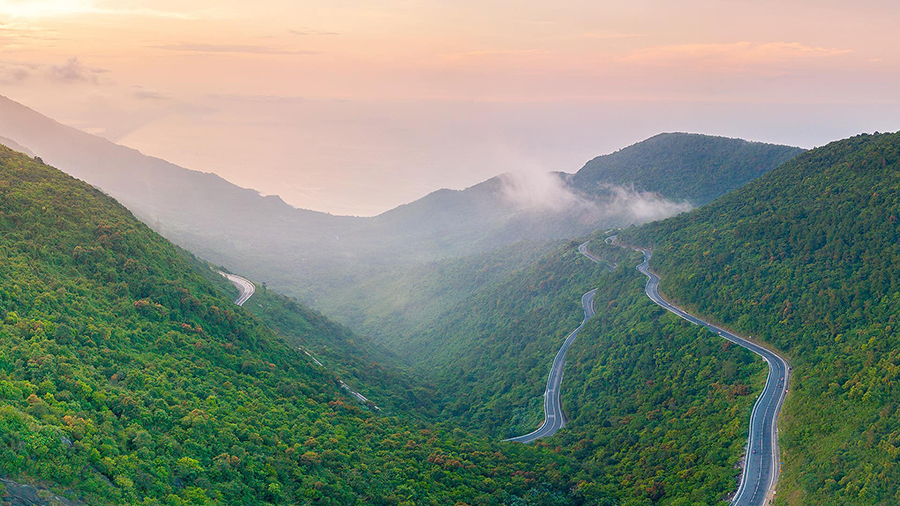 The spectacular views from the Hai Van Pass, a scenic highlight of the Da Nang to Hue route. A winding road with breathtaking mountain and ocean views from the famous Hai Van Pass in Vietnam.
